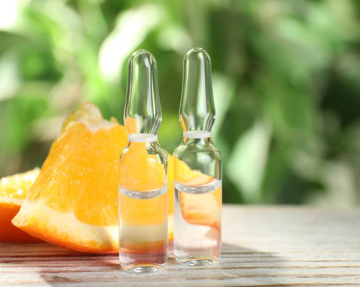 Vitamin injections vials with slices of oranges